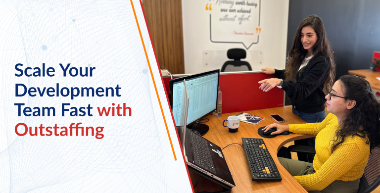 Software Developers working together and one is pointing to the other screen.